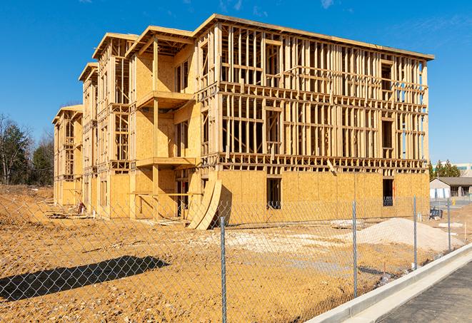 a temporary chain link fence locking away a building under renovation, serving as a security tool in Firebaugh